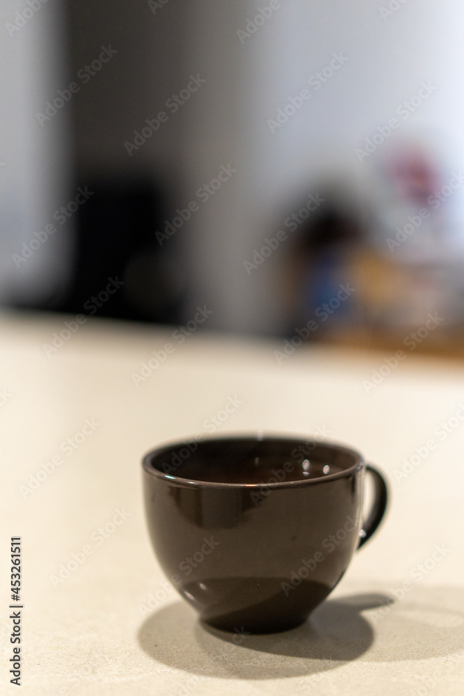 cup of hot black coffee on marble kitchen bench cup of hot black coffee on marble kitchen bench