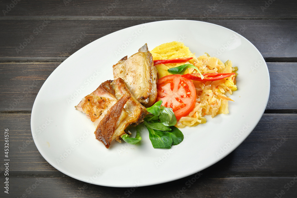 grilled pork on a plate on wooden table