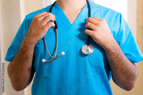 Crop doctor with stethoscope in hospital