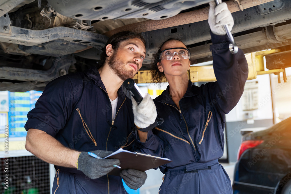 Technician worker working and using wrench tool for maintenance car