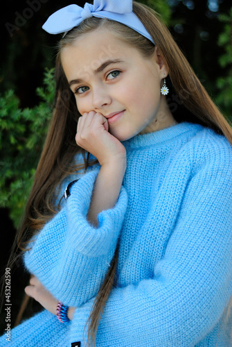 beautiful teenage girl with long hair wearing blue glasses and a plaid shirt portrait
