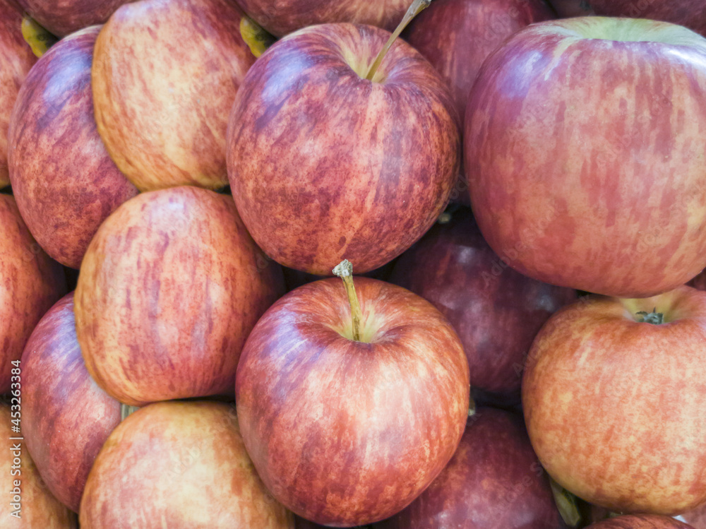 Gala apples (Malus domestica), vertical stripes, orange, red, yellow colors. Stacked in piles. Bangkok, Thailand. Gala apples (Malus domestica), vertical stripes, orange, red, yellow colors. Stacked in piles. Bangkok, Thailand.