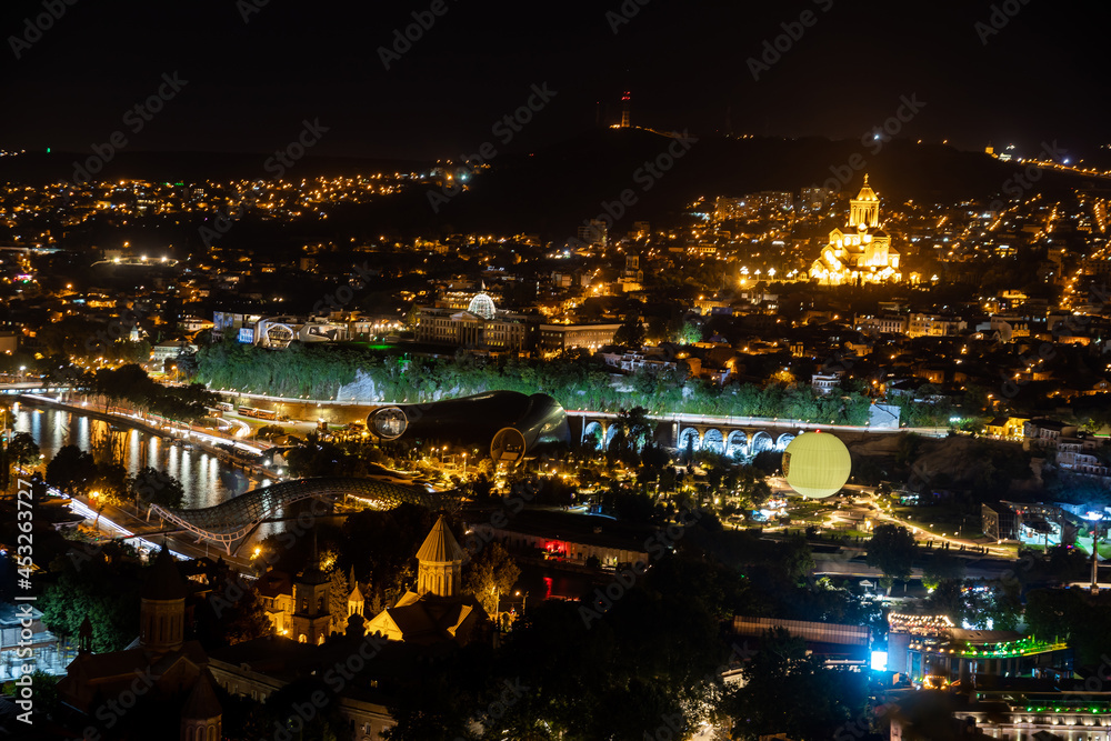 Tbilisi city panorama at night. Old city, new Summer Rike park, river Kura, the European Square and the Bridge of Peace