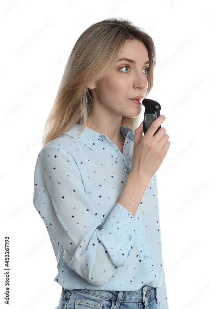Young woman blowing into breathalyzer on white background Young woman blowing into breathalyzer on white background