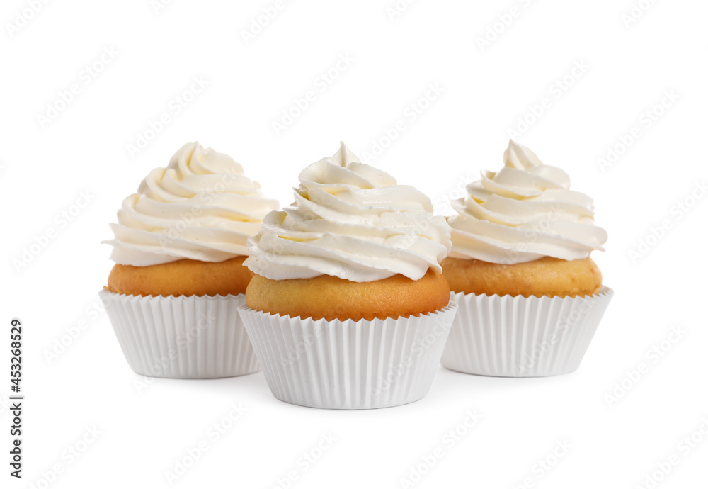 Delicious cupcakes decorated with cream on white background