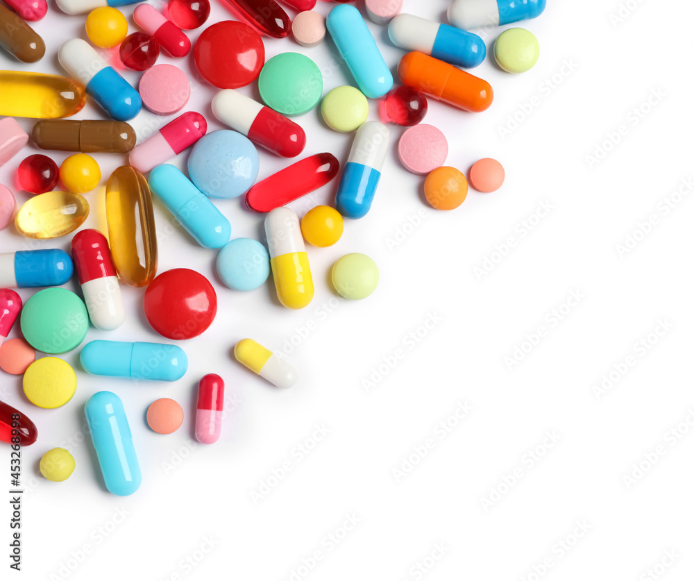 Lots of different colorful pills isolated on white, top view Lots of different colorful pills isolated on white, top view