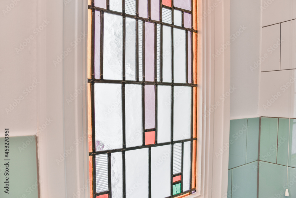 Mosaic window and tiled wall in house Mosaic window and tiled wall in house