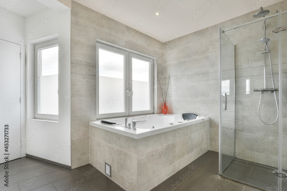 Modern bathroom with shower cabin and bathtub Modern bathroom with shower cabin and bathtub
