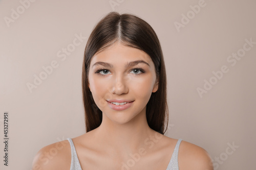 Portrait of pretty girl on light background. Beautiful face with perfect smooth skin