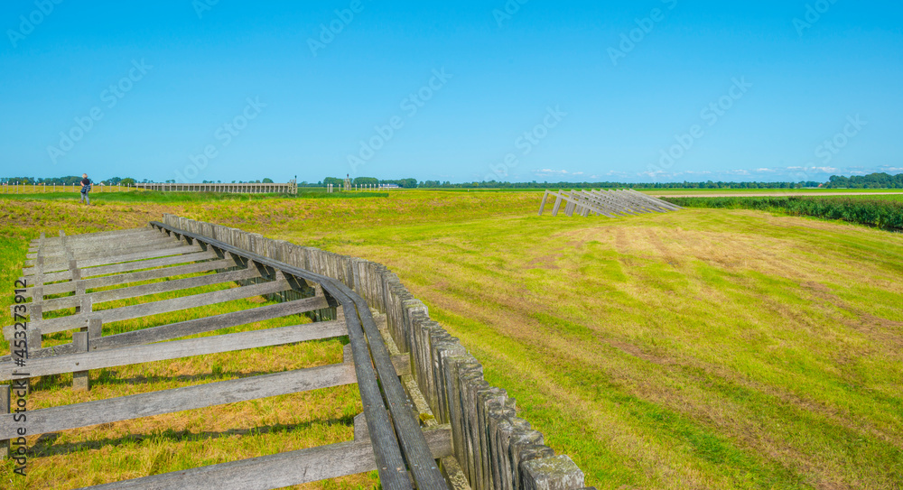Unesco protected outline of an ancient former harbor of an island swallowed by reclaimed new land under a blue sky in summer, Noordoostpolder, Schokland, Flevoland, Netherlands, August 23, 2021