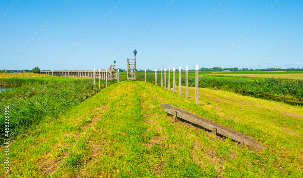 Unesco protected outline of an ancient former harbor of an island swallowed by reclaimed new land under a blue sky in summer, Noordoostpolder, Schokland, Flevoland, Netherlands, August 23, 2021