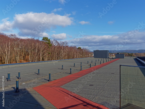 The Flat Roof with a Red Access Path of the Scandic Flesland airport Hotel in Bergen on a cold bright day in April.