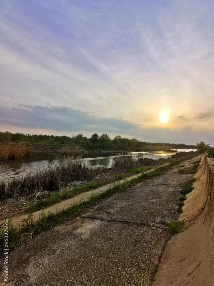 Fototapeta premium Wetland at sunset, natural delta near the city