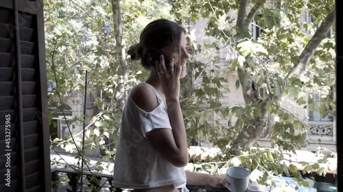 Young woman talking on phone at home.