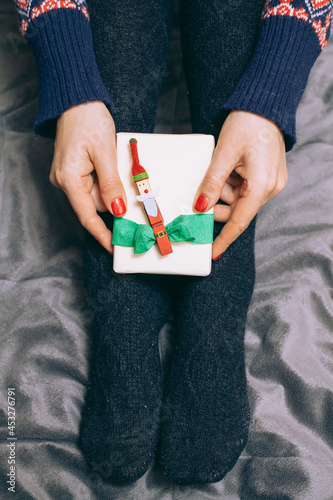 Girl Holding Holiday Gift On Her Feet