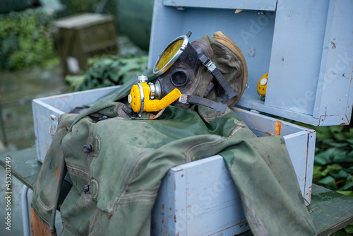 old scuba diving. Diver's equipment. A mask, fins and a green diving suit. Clothing for diving under water with an oxygen tank in Navy.