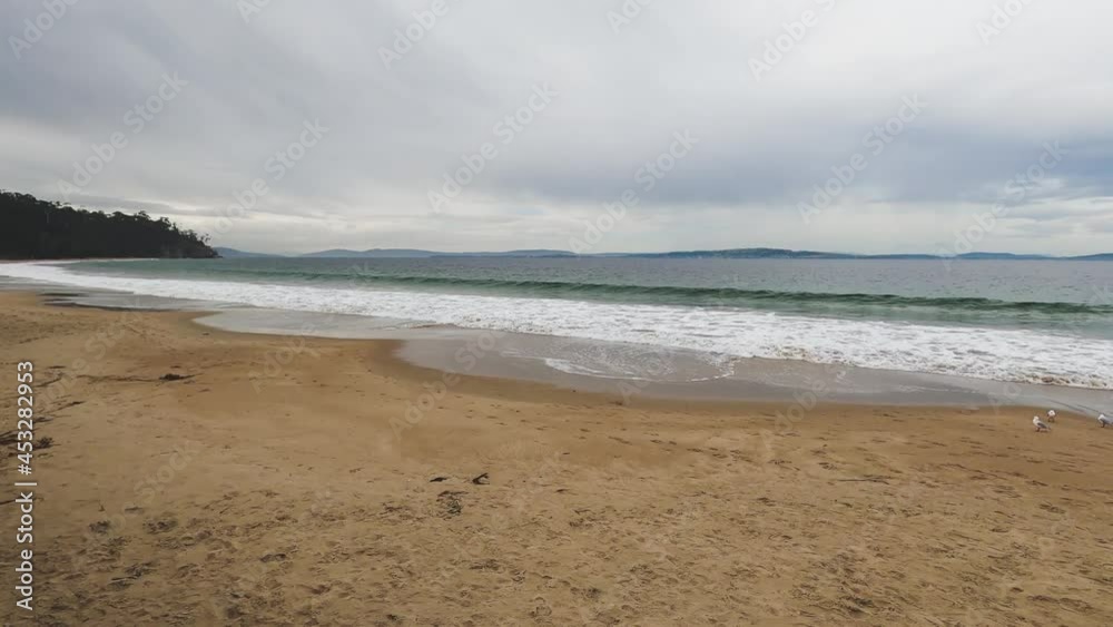 overcast stormy day over a pristine beach in Southern Tasmania with no people overcast stormy day over a pristine beach in Southern Tasmania with no people