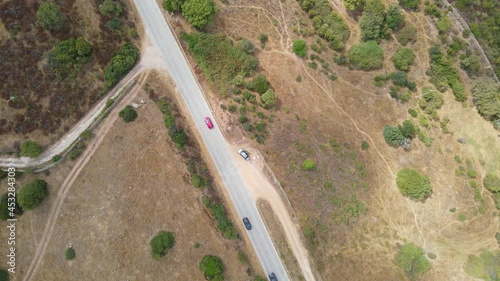 Top view of car traffic on the highway outside the city, with a slight approach to the road
