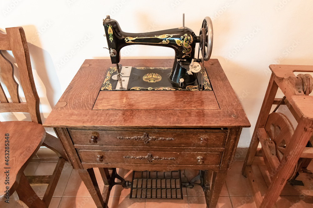 Old sewing machine in wooden furniture