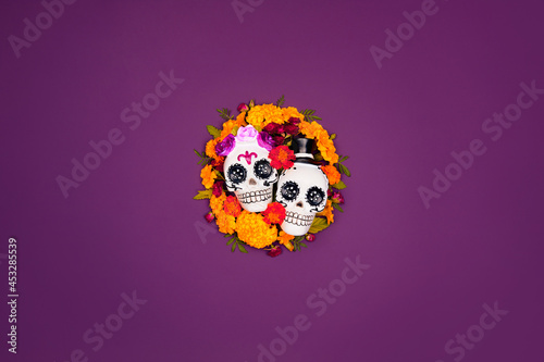 Day of the dead, Dia De Los Muertos, halloween Celebration Background. Sugar Skull, calaverita, marigolds flowers, purple Copy Space. Traditional Mexican culture festival flyer. Flat lay, top view.