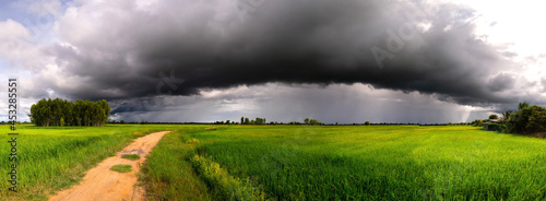 Fotografie, Obraz Panorama road to Dark sky and dramatic black cloud before rain