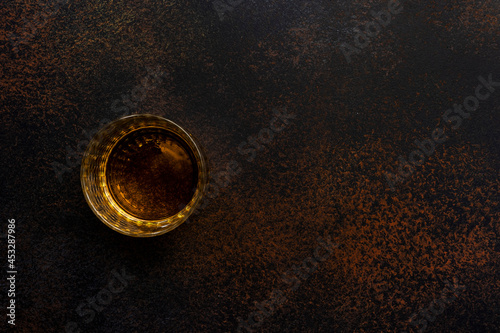 American bourbon whiskey in glass, black background with negative space