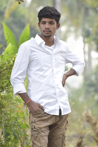 Handsome Men Posing In White T Shirt On Outdoor Nature Background. Men Holding Shirt on Hands. Indian Men  Men Model from Asia. Walking.