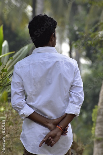 Handsome Men Posing In White T Shirt On Outdoor Nature Background. Men Holding Shirt on Hands. Indian Men  Men Model from Asia. Walking.