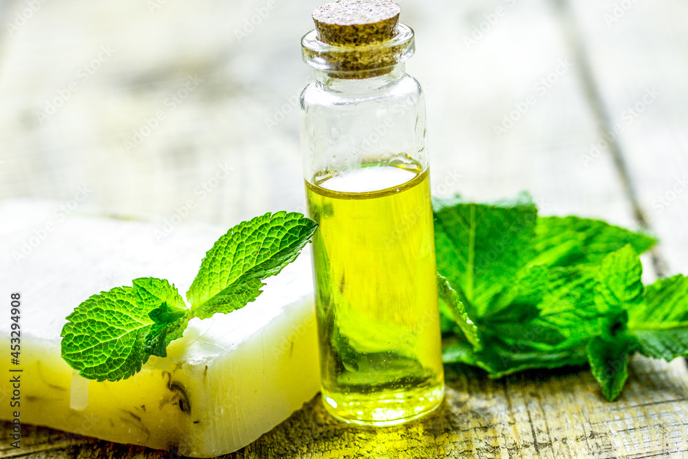 herbal extract in glass bottles and soap for spa on wooden table background herbal extract in glass bottles and soap for spa on wooden table background
