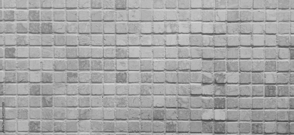 Naklejka premium Mosaic. Black and white colors. Ceramic mosaic texture. Small stone tiles. Horizontal square abstract background.