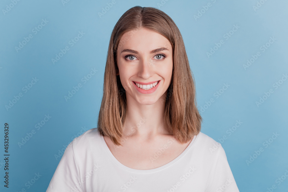 Portrait of cheerful positive adorable girl look camera shiny smile on blue background Portrait of cheerful positive adorable girl look camera shiny smile on blue background
