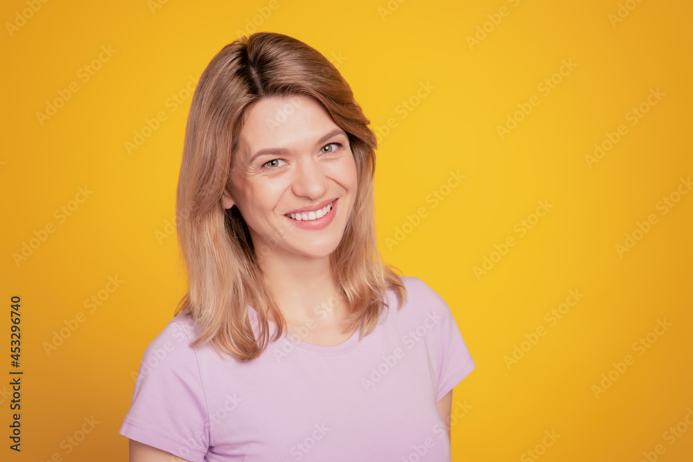 Portrait of positive cheerful lady posing look camera enjoy free time on yellow background Portrait of positive cheerful lady posing look camera enjoy free time on yellow background