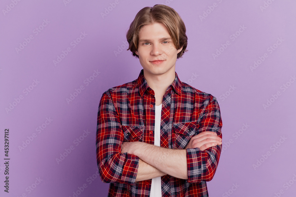 Portrait of self-assured handsome guy crossed hands look camera on violet background Portrait of self-assured handsome guy crossed hands look camera on violet background