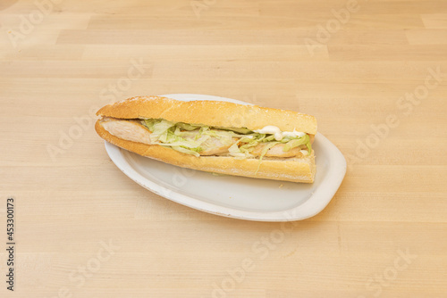 Traditional chicken sandwich with lettuce and mayonnaise on white tray