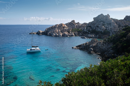 little old boat anchored in a turquoise of Cala Spinosa - bay in the La Maddalena Archipelago - sardinia travel destination.