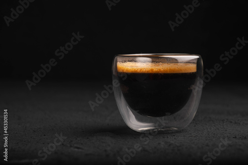 Black coffee in a glass on a dark background