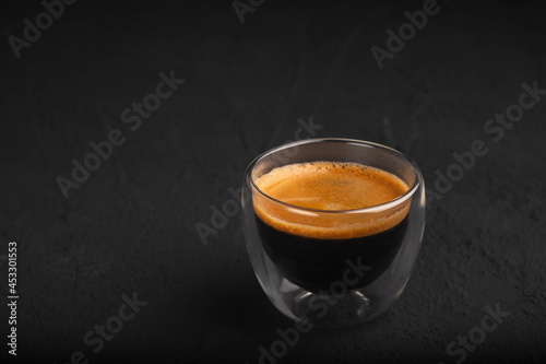 Black coffee in a glass on a dark background