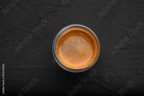 Black coffee in a glass on a dark background