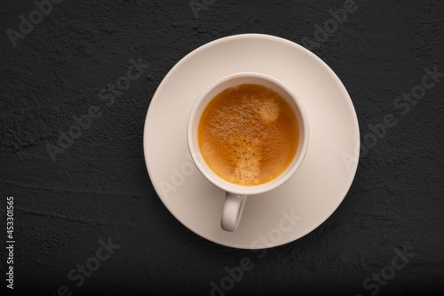 Espresso in a white cup on a dark background
