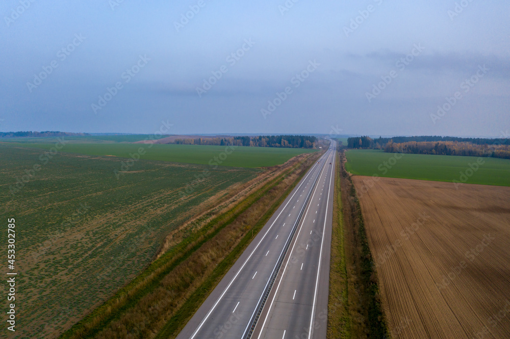 Aerial view of freeway road in autumn forest.