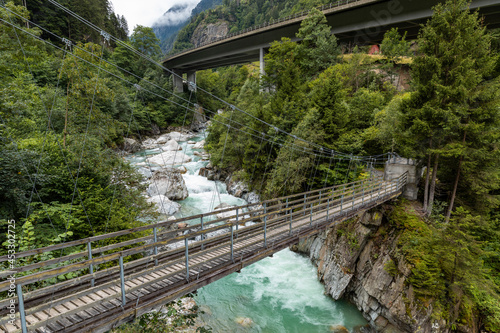Suspension bridge over the Reuss river with rapids at Gurtnell in German-speaking Switzerland.