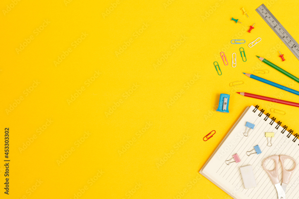Fototapeta premium Top view notebooks and accessories studying in the library at school yellow background idea education