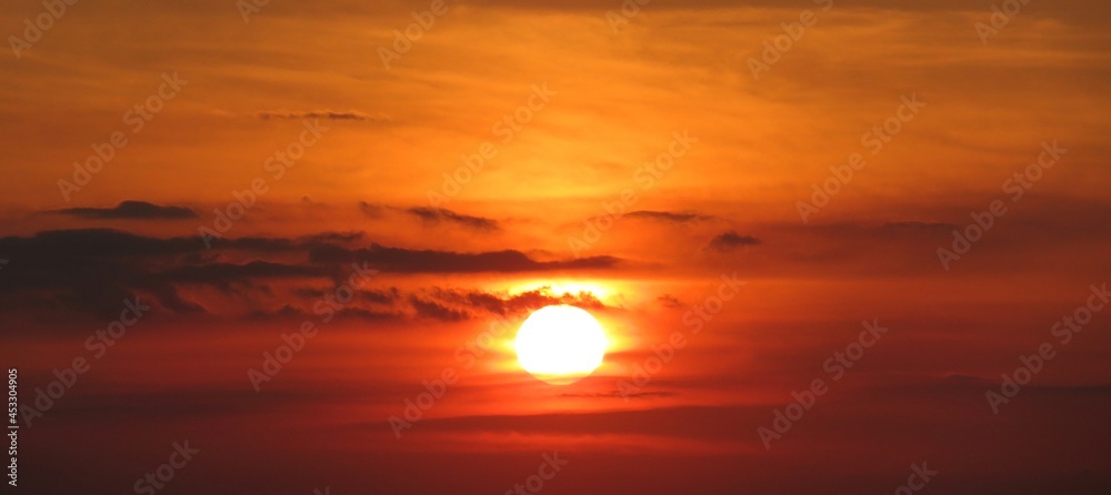 Panoramic view on beautiful fiery orange sunset in the sky Panoramic view on beautiful fiery orange sunset in the sky