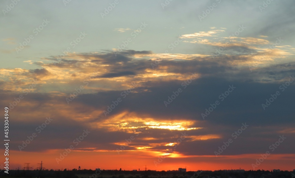 Beautiful red sunset with dark clouds, natural background