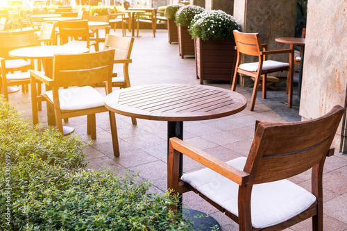 Tables in a summer street cafe without people.