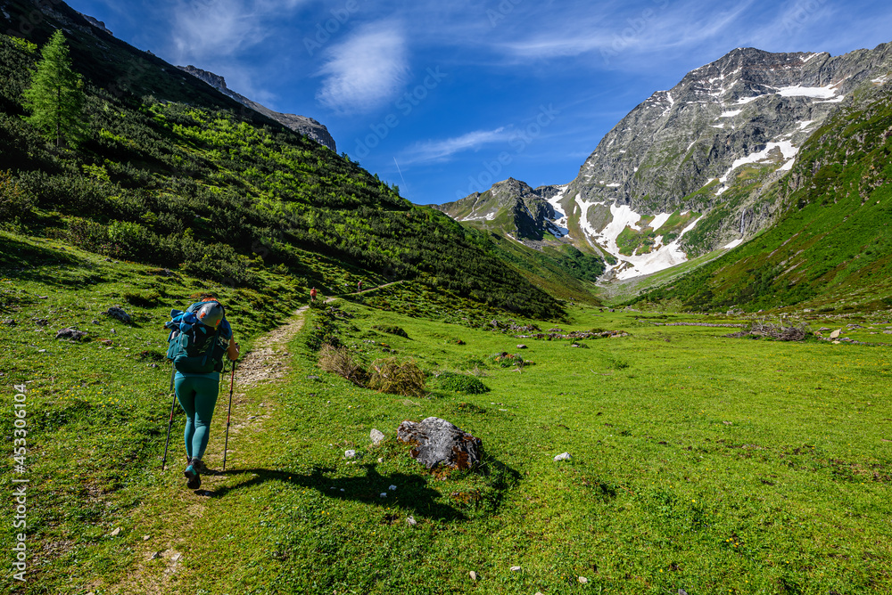 Several tourists starting their hike from Karalm towards the Habicht summit in Stubai Alps, Austria.