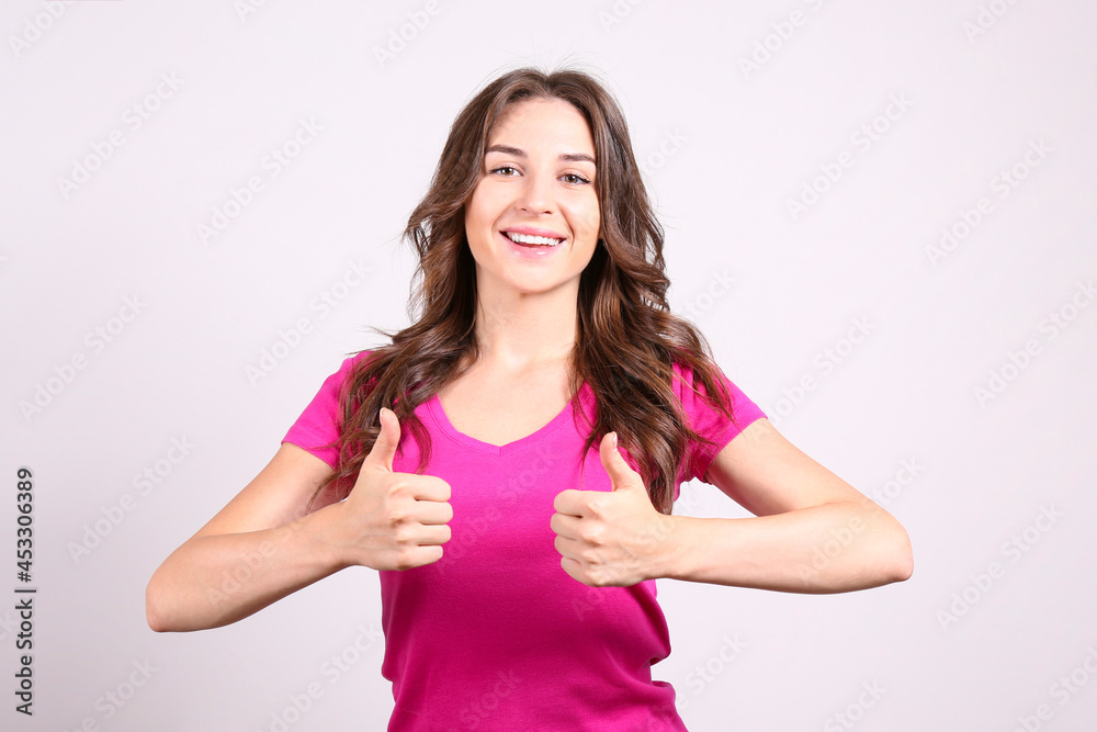 Young beautiful brunette woman with long wavy hair wearing pink shirt, posing over white isolated background. Portrait of female model showing gestures and emotions. Close up, copy space. Young beautiful brunette woman with long wavy hair wearing pink shirt, posing over white isolated background. Portrait of female model showing gestures and emotions. Close up, copy space.