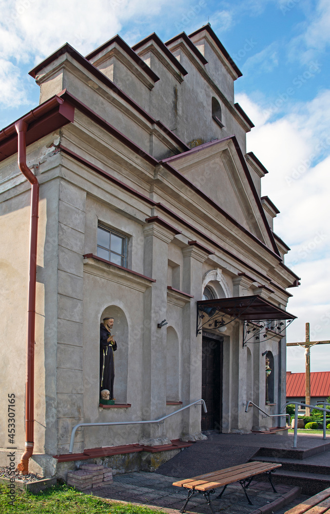 General view and architectural details of the built in 1840 together with the belfry. Classicist Catholic Church of St. Adalbert in the village of Poryte in Podlasie, Poland.
