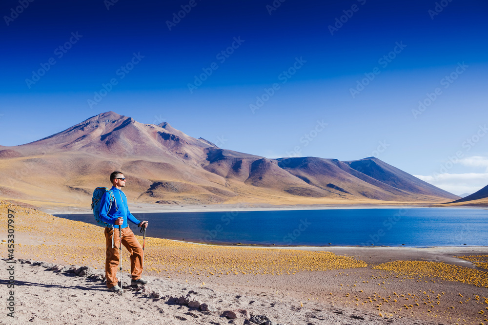 Hiker looking at view during a hiking trip with beautiful volcano landscape Atacama desrt. Chile Hiker looking at view during a hiking trip with beautiful volcano landscape Atacama desrt. Chile