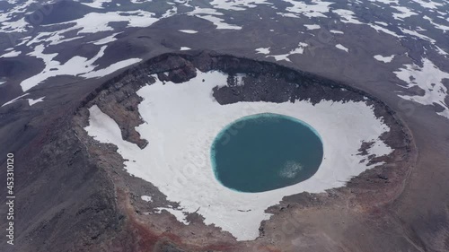 The blue lake in the crater of Gorely volcano. Kamchatka Peninsula, Russia